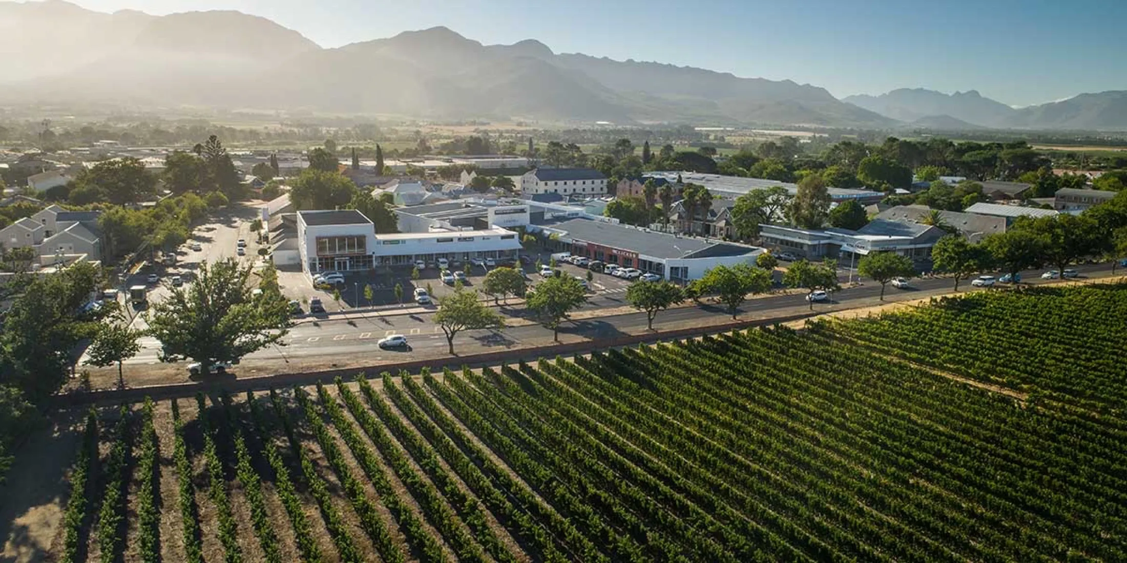 Laborie Centre from the air, over the vineyards of Southern Paarl with the mountains behind.