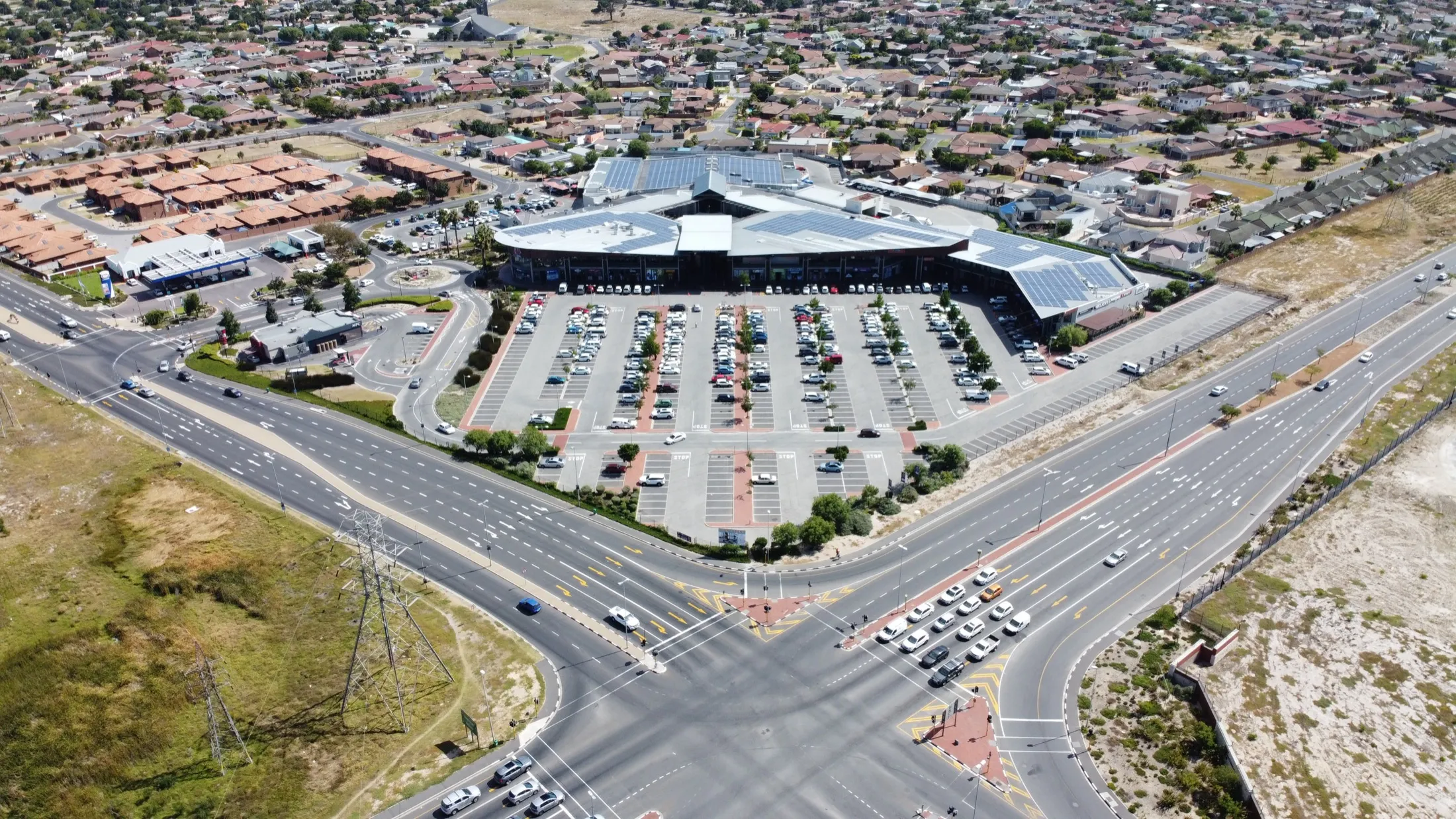 Aerial view of Ipic Shopping Centre Soneike at the Bottelary Road and Amandel Way intersection: the solar-roofed centre and its parking courts.